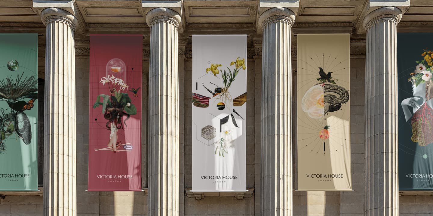 Four vertical banners with surreal botanical artwork and Victoria House London text hang between columns on a neoclassical building façade.