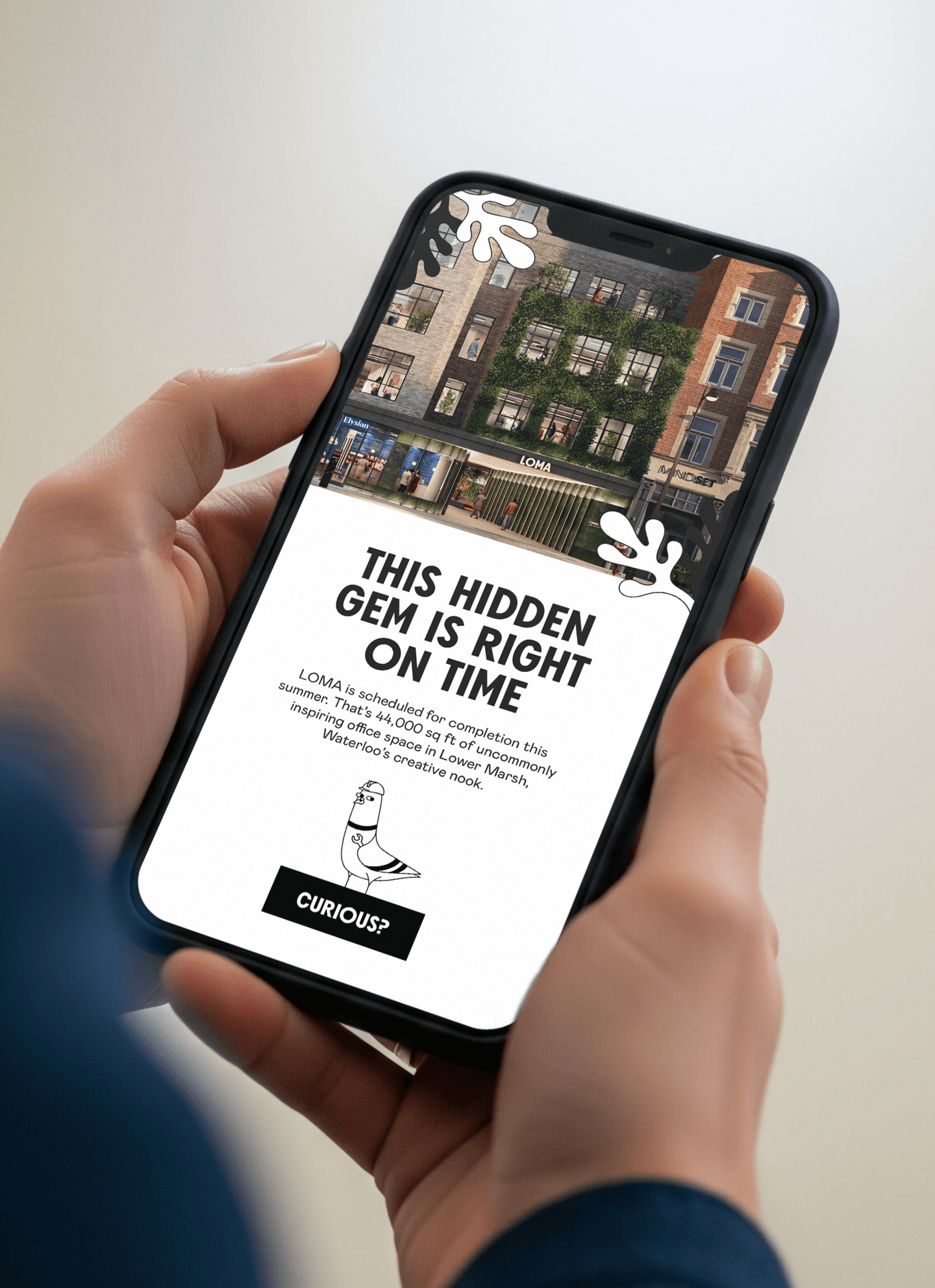 A person holds a mobile phone displaying a promotional webpage for LOMA, featuring an image of a building and the text, THIS HIDDEN GEM IS RIGHT ON TIME.