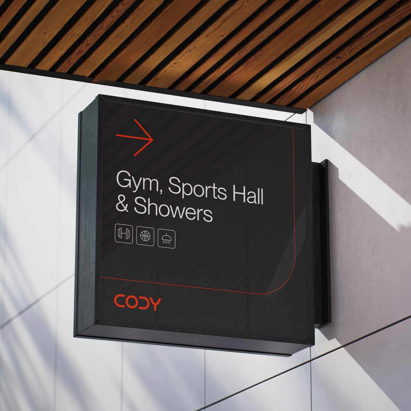 A wall-mounted black sign with red accents directs to the gym, sports hall, and showers, featuring icons for each facility and the word CODY at the bottom.